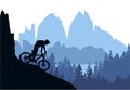 Silhouette of mountain bike rider in wild nature landscape. Mountains, forest and lake in background. Royalty Free Stock Photo