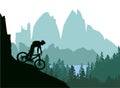 Silhouette of mountain bike rider in wild nature landscape. Mountains, forest and lake in background. Royalty Free Stock Photo