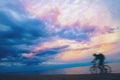Mountain biker on beach and sunset Royalty Free Stock Photo