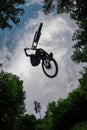 Silhouette of a mountain biker jumping over camera and performin Royalty Free Stock Photo