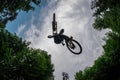 Silhouette of a mountain biker jumping over camera and performin Royalty Free Stock Photo