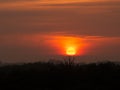 Silhouette mountain hill with big sun at sunrise sunset. Orange and yellow sky and clouds Royalty Free Stock Photo