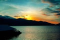 Silhouette of mountain , landscape sunrise on sky and lake view with shadow of floating raft house on background