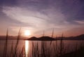 Silhouette of mountain, plant cloud and ocean at sunset Royalty Free Stock Photo