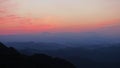 Silhouette of mountain range with beautiful layers of it`s peak and orange sunset background Royalty Free Stock Photo