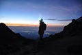 Silhouette of a Mountaineer standing on a Mountain in front of t