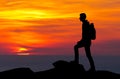 Silhouette of a mountaineer standing on the top