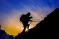 Silhouette of mountaineer and sunset.