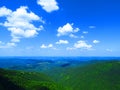 Silhouette of mountains in Bulgaria in summer and many white clouds in the blue sky. Mountainous view. Royalty Free Stock Photo