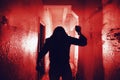 Silhouette of murderer with knife in hand. Scary thriller style in red color. Horror movie killer concept Royalty Free Stock Photo