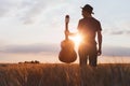 Silhouette of musician with guitar, play music