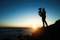 Silhouette of lone musician play on Tuba on the ocean coast at sunset. Royalty Free Stock Photo