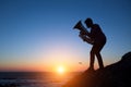 Silhouette of musician play Tuba on sea shore at amazing sunset .Art.