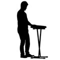 Silhouette musician plays the synthesizer on a white background Royalty Free Stock Photo