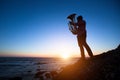 Silhouette of musician with Tuba on rocky sea coast