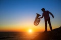 Silhouette of musician with the Tuba on rocky sea coast Royalty Free Stock Photo