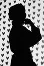 Silhouette of a muslim girl, hearts in the background.