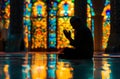 Silhouette of muslim man sitting while raised hands and praying in mosque with Islamic concept Royalty Free Stock Photo