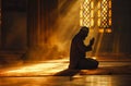 Silhouette of muslim man sitting while raised hands and praying in mosque with Islamic concept Royalty Free Stock Photo