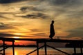 Silhouette Muslim man walk on the wooden jetty