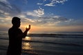 Silhouette of Muslim pray near the beach