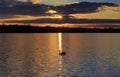 Silhouette of Mute Swan, Clouds and sunset reflected in the ripples of Ravensthorpe reservoir Royalty Free Stock Photo