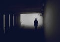 Silhouette of mysterious man in misty tunnel. Royalty Free Stock Photo