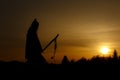 silhouette of native american shaman with pikestaff on background of sunset beutiful in mountains Royalty Free Stock Photo