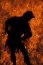 Silhouette of Native American woman lean over fire