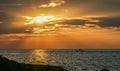 A small fishing boat moored in the middle of the sea during sunset in Thailand Royalty Free Stock Photo