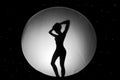 Silhouette of nude girl, against a white background in the form of a circle in black space Royalty Free Stock Photo