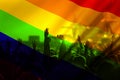 silhouette of a parade of gays and lesbians with a rainbow flag - symbol of love and tolerance