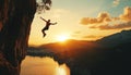 Silhouette ofclimber rappelling down from cliff during sunset symbolizing determinatio, progress. Warm light outlines figure Royalty Free Stock Photo
