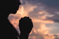 Silhouette off young woman praying for God`s blessings with th Royalty Free Stock Photo