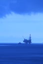 Silhouette Offshore Jack Up Drilling Rig and Boat (BlueTone) Royalty Free Stock Photo