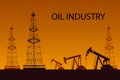 Silhouette of oil or gas drilling rigs on a sunset background.