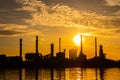 Silhouette of oil and gas refinery industry plant with glitter lighting and sunrise in the morning, Royalty Free Stock Photo