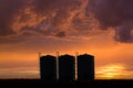 Oil refinery tanks at sunset Royalty Free Stock Photo