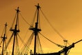 Silhouette of an old, ancient, wooden ship with masts on a sunset background Royalty Free Stock Photo