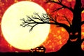 Silhouette of an old black tree with a grimace on the trunk against the background of an orange sky with the moon
