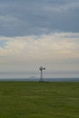 Old Fashioned Windmill along the horizon of a North Dakota Prairie Royalty Free Stock Photo