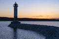 Silhouette of the old Finnish lighthouse of the Vuohensalo in April sunset. Ladoga lake, Leningrad region Royalty Free Stock Photo