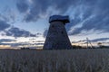 Silhouette of old mill without a wheel at Sunset