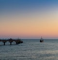 Silhouette of an old Viking ship saling off into the sunset on the Baltic Sea Royalty Free Stock Photo