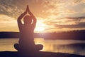 Silhouette of old woman yoga near lake during sunset, Relax time and exercise