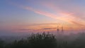 The silhouette of the Orthodox Church at sunrise in the morning fog. Blurred background.