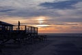 Silhouette of outdoor terrace of beach pavilion `Paal 17` with sunset sea scene in background on island Texel in Netherlands Royalty Free Stock Photo