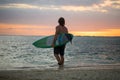 Silhouette paddle board surfer on the sunset background.