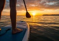 Silhouette of paddleboarder on tranquil water during vibrant sunset Royalty Free Stock Photo