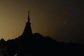 Silhouette of pagoda buddhism against golden night sky with stars